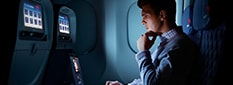 Man watching seat-back screen