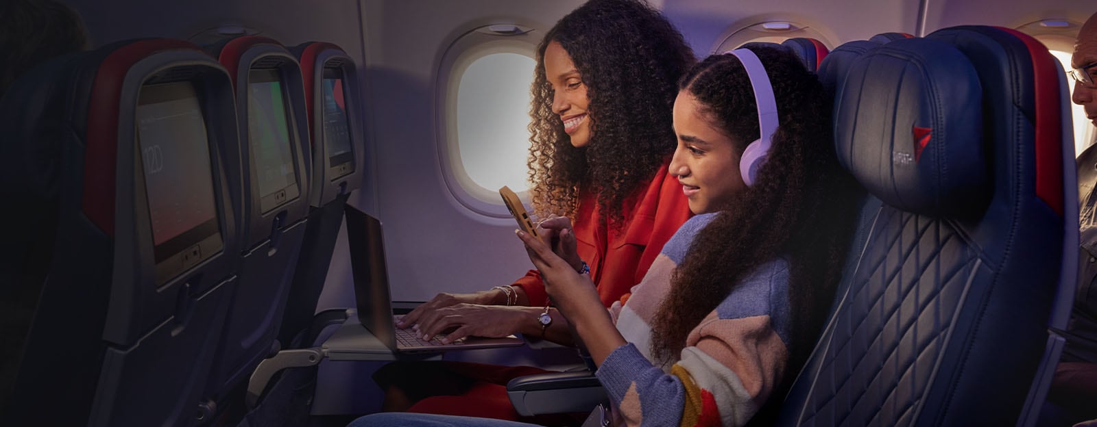 Passengers enjoying in-flight entertainment and wifi