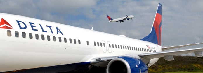 Delta plane on ground with one flying over